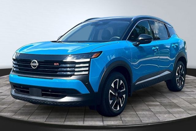 2025 Nissan Kicks SR in Arctic Ice Blue Metallic/Super Black — front three-quarter view